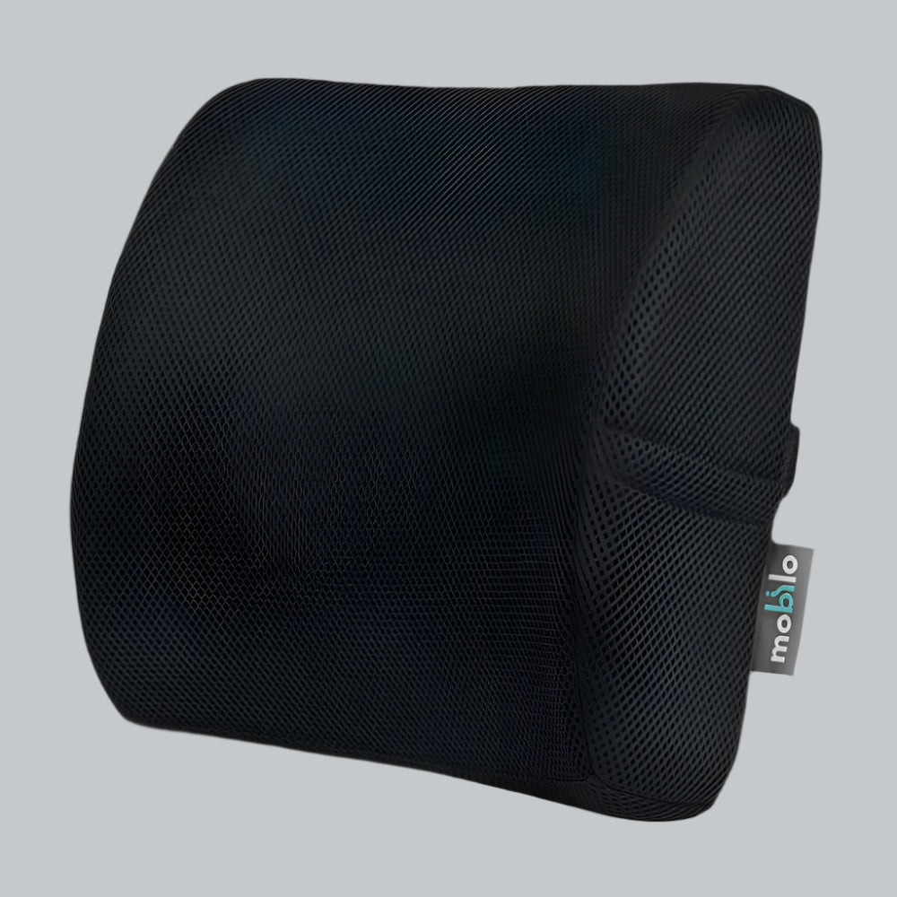 Black high-density memory foam lumbar pillow holding its firm shape, with mesh cover and strap, on a light studio surface.