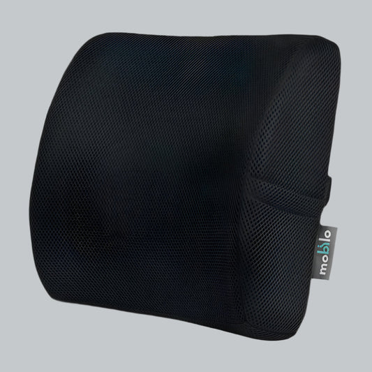 Black high-density memory foam lumbar pillow holding its firm shape, with mesh cover and strap, on a light studio surface.